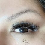 A client's eyes with voluminous lash extensions 9D volume applied by Mini Beauty Eyelash for a glamorous effect in Los Angeles and Orange County.